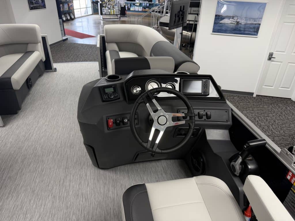 Boat helm with steering wheel and controls at Hall's Sport Center.