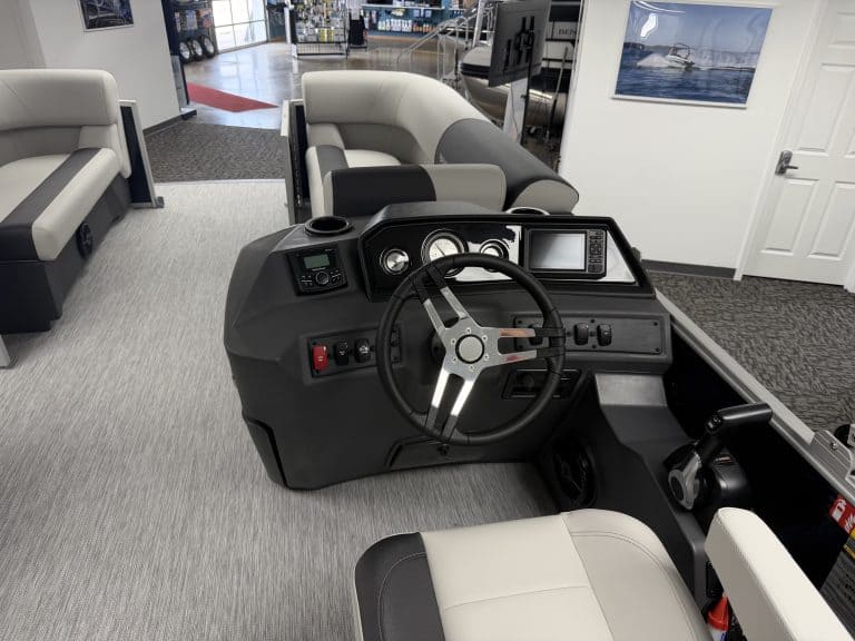 Boat helm with steering wheel and controls at Hall's Sport Center.