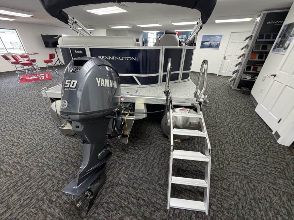 Bennington 20SL S1 pontoon boat with Yamaha engine on showroom floor.