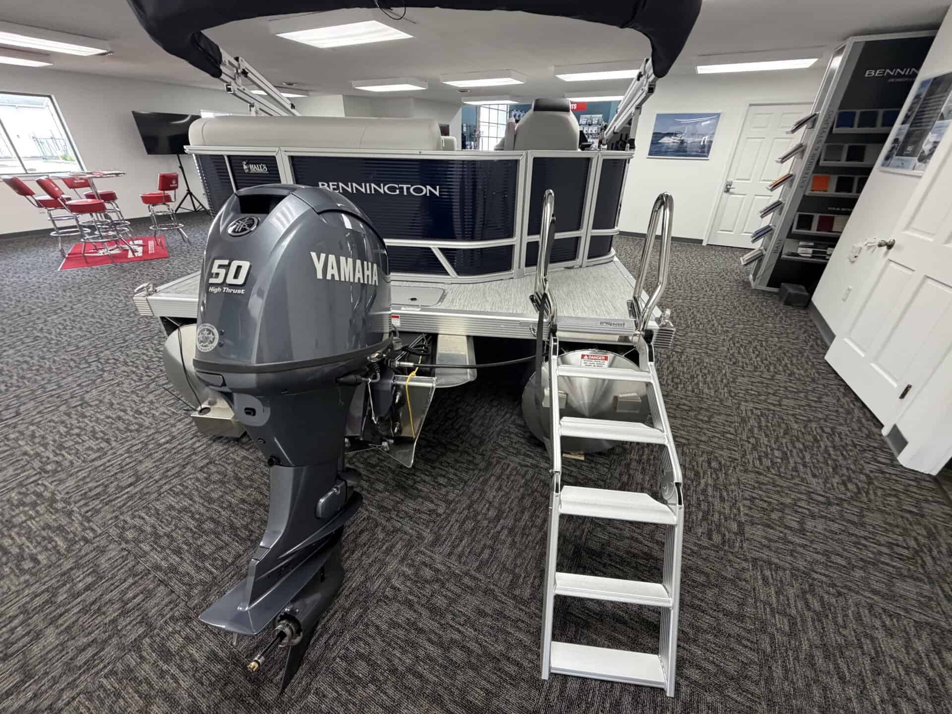 Bennington 20SL S1 pontoon boat with Yamaha engine on showroom floor.