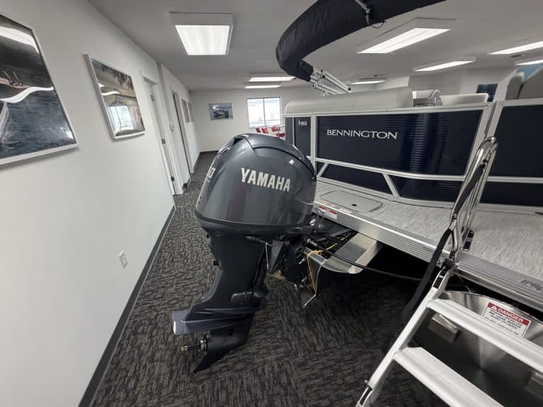 Bennington 20SL S1 pontoon boat with Yamaha engine inside Hall's Sport Center.
