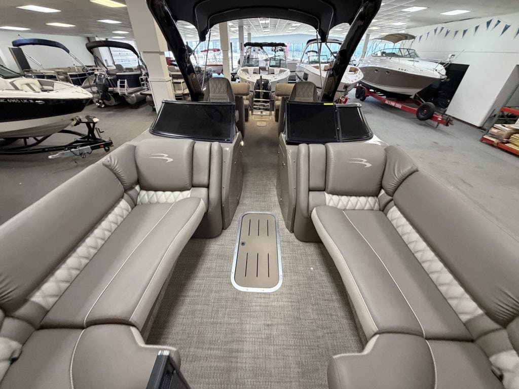 Interior view of a Bennington 25QXFBWA pontoon boat at Hall's Sport Center.
