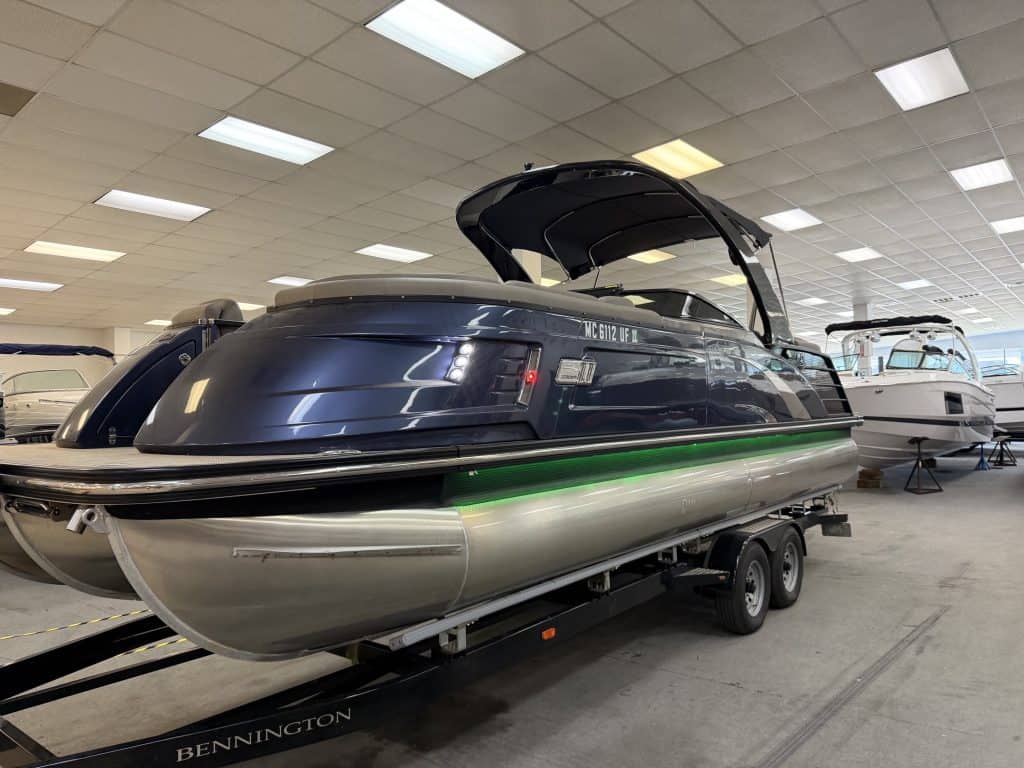 Bennington 25QXFBWA pontoon boat inside Hall's Sport Center.