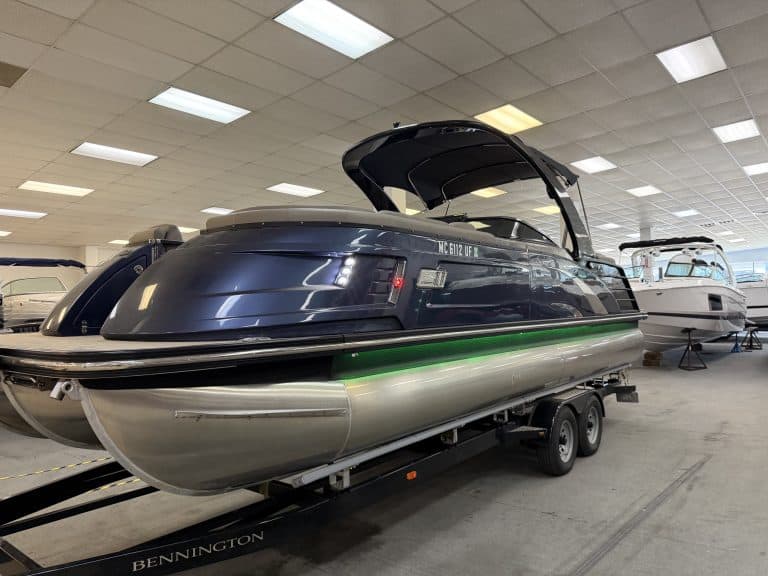 Bennington 25QXFBWA pontoon boat inside Hall's Sport Center.