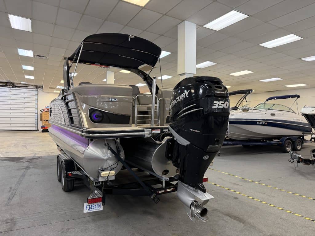 Bennington pontoon boat with Mercury 350 engine in showroom.
