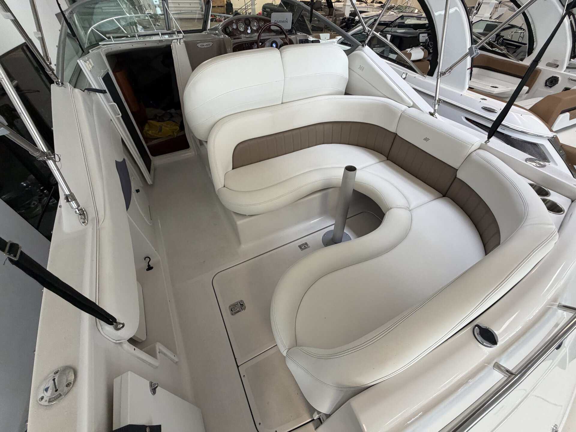 Interior view of a 2004 Four Winns 268 VISTA boat with white seating.