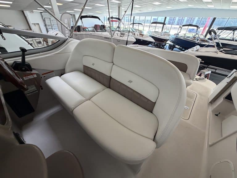 White boat seating with beige accents inside a marina showroom.