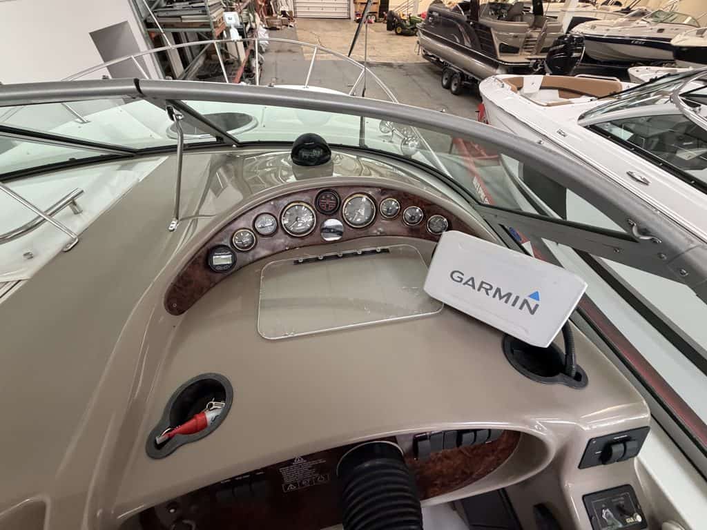 Close-up of boat dashboard with Garmin GPS and navigation instruments.