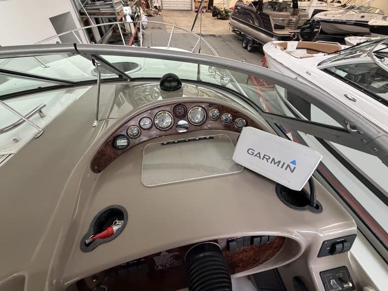 Close-up of boat dashboard with Garmin GPS and navigation instruments.