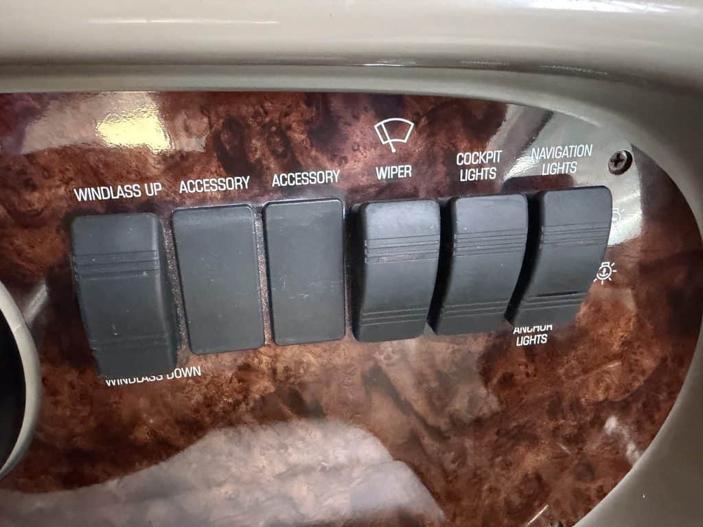 Boat control panel with switches for windlass, accessories, wiper, cockpit lights, and navigation.
