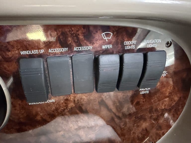 Boat control panel with switches for windlass, accessories, wiper, cockpit lights, and navigation.