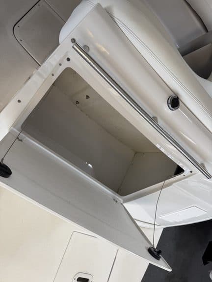Open storage compartment of a Four Winns 268 VISTA boat.