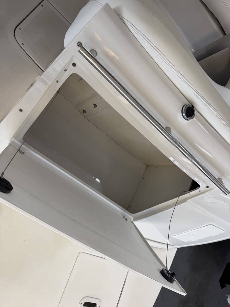 Open storage compartment of a Four Winns 268 VISTA boat.