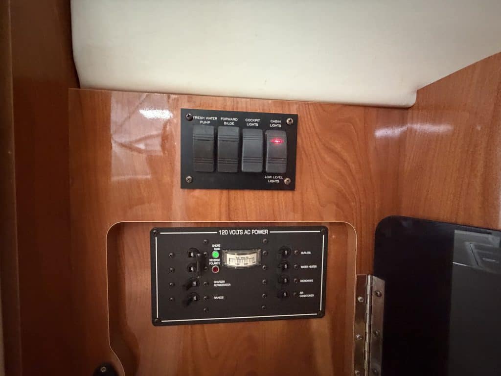 Boat electrical panel with switches and circuit breakers for power management.