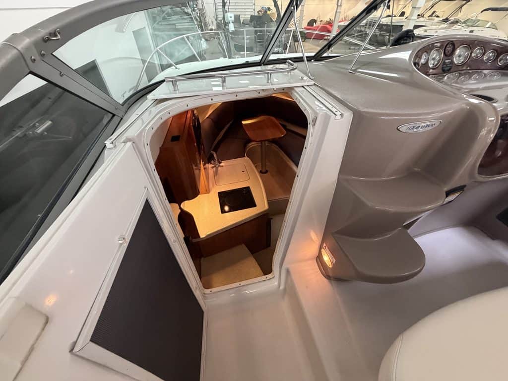 View of boat interior with seating and dashboard in a 2004 Four Winns 268 VISTA.