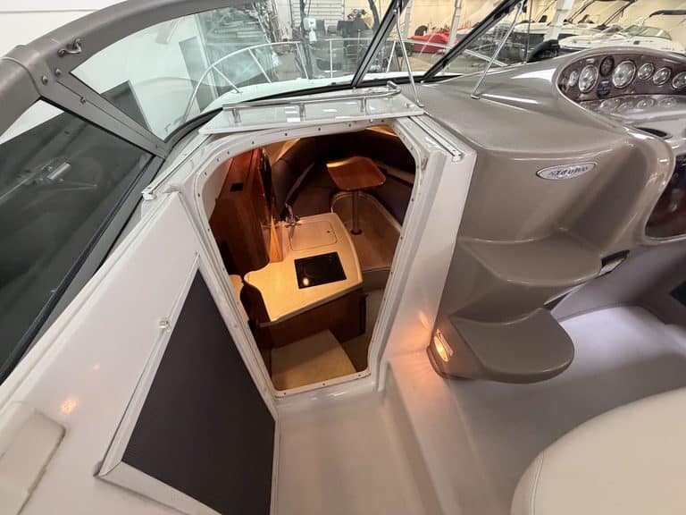 View of boat interior with seating and dashboard in a 2004 Four Winns 268 VISTA.
