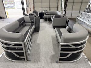 Boat seating area with multiple gray and black cushioned seats at Hall's Sport Center.