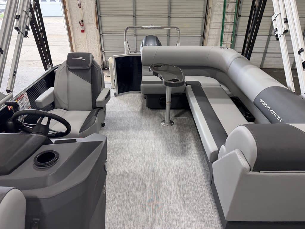 Interior view of a Bennington 20S1 SL pontoon boat with seating and steering area.