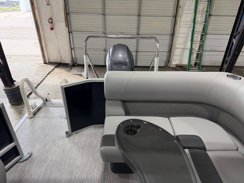 Indoor boat showroom with seating and boat engine display at Hall's Sport Center.