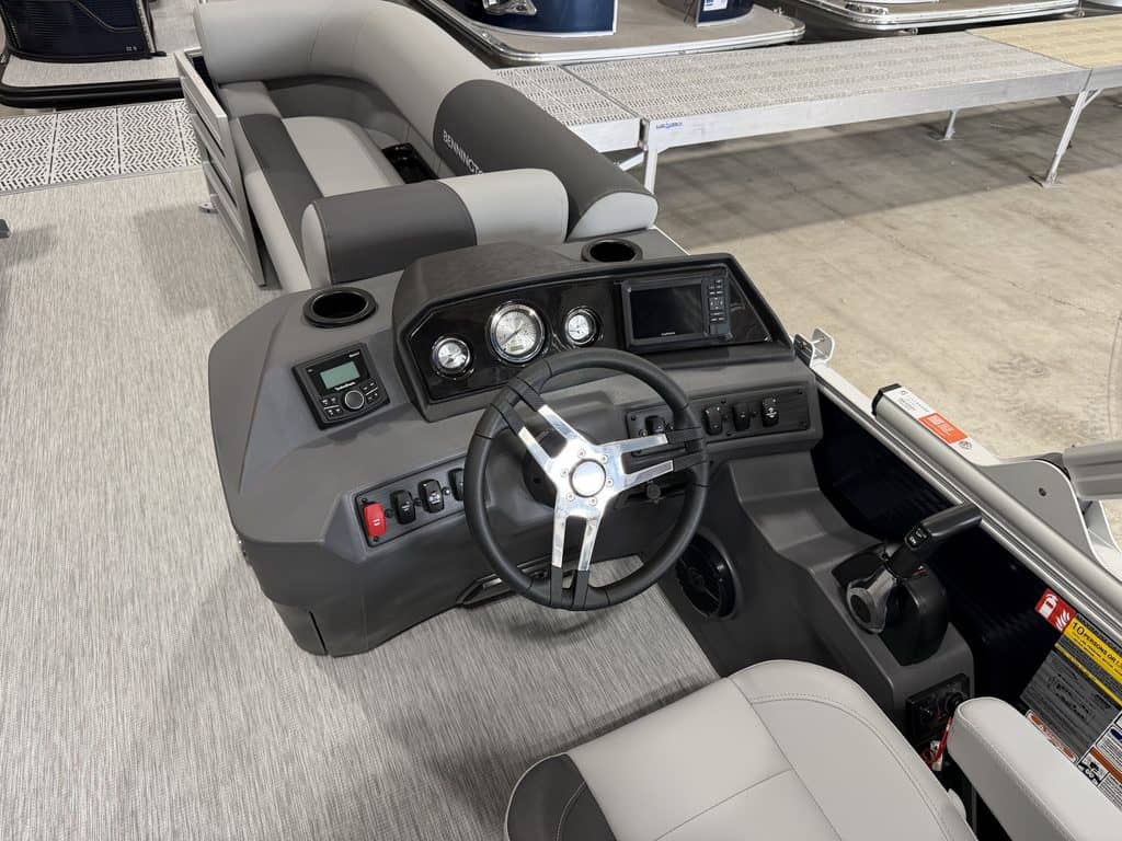 Pontoon boat console with steering wheel and controls at Hall's Sport Center.