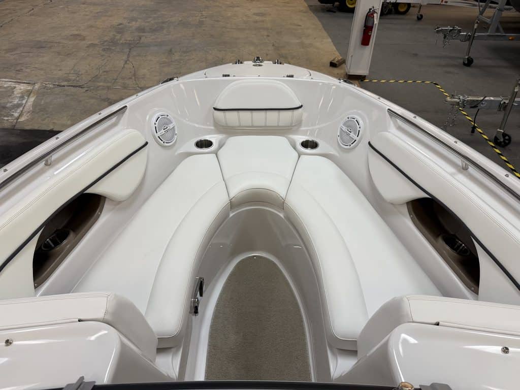 Interior view of a white Four Winns 220 Horizon boat with seating and speakers.