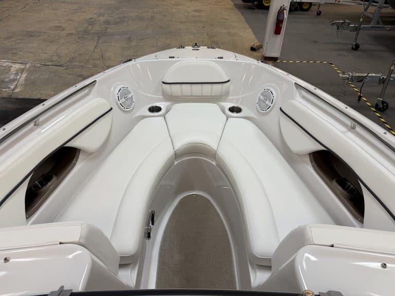 Interior view of a white Four Winns 220 Horizon boat with seating and speakers.