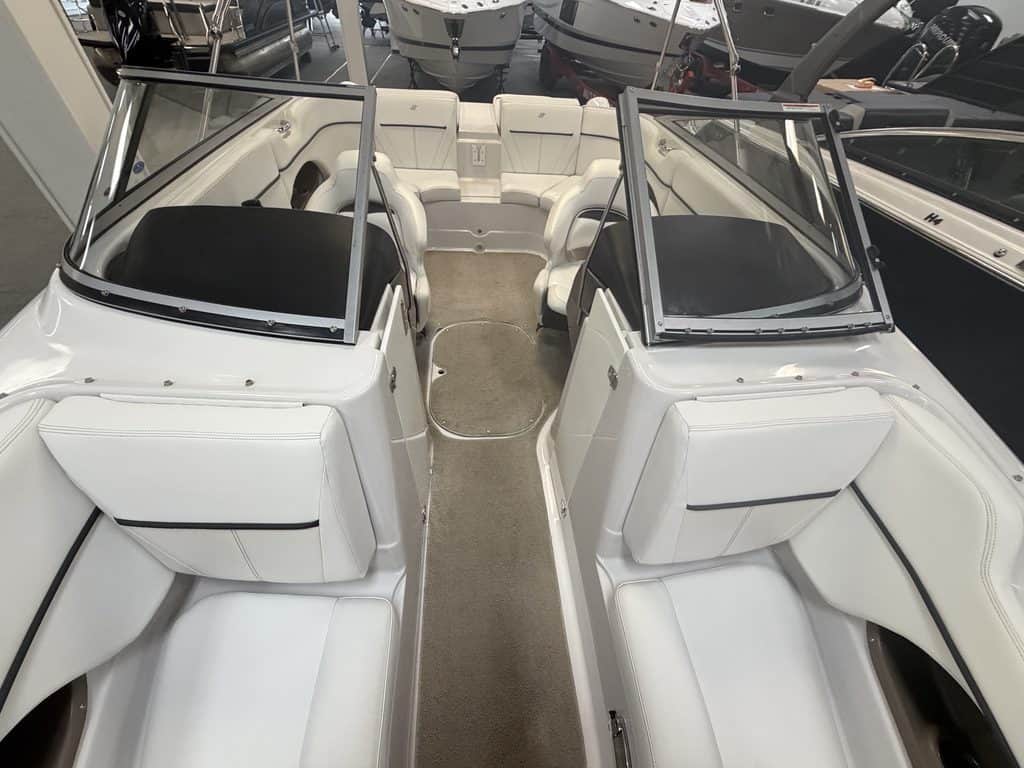 Interior view of a 2011 Four Winns 220 Horizon boat with seating and windshield.