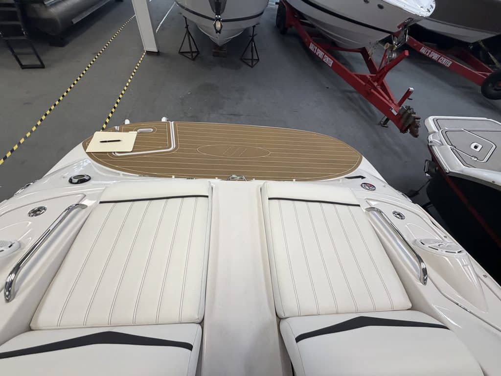 View of the boat's deck with seating and a sun pad at Hall's Sport Center.
