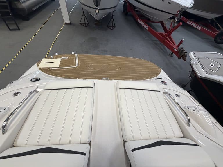 View of the boat's deck with seating and a sun pad at Hall's Sport Center.