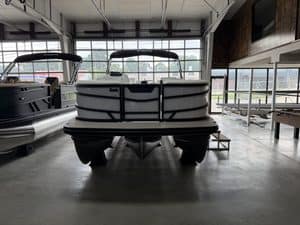 Pontoon boat displayed at Hall's Sport Center for sale or demo.