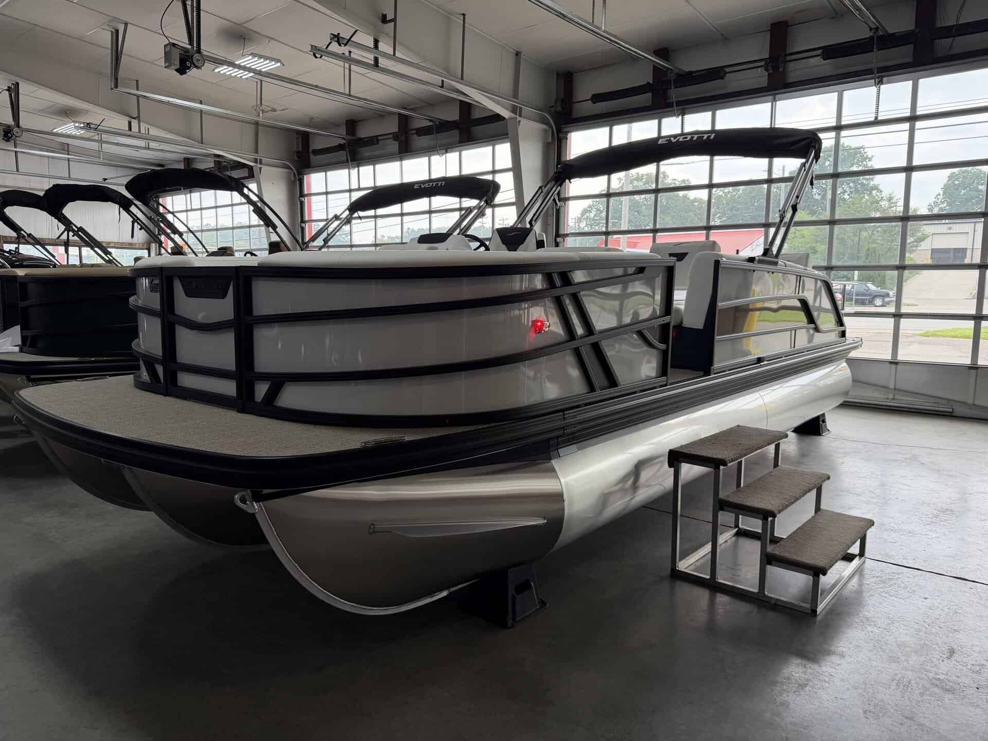 Luxury pontoon boat at Hall's Sport Center with steps for easy access.