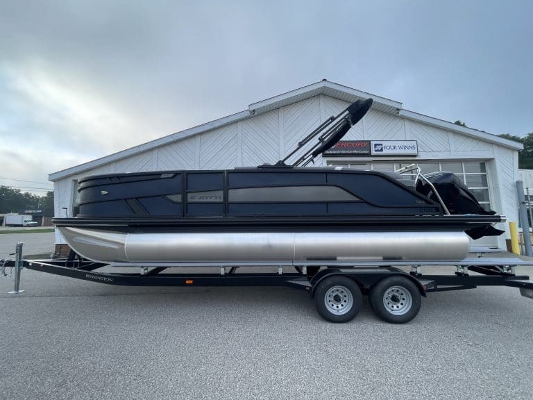 Black and silver pontoon boat on trailer at Hall's Sport Center.