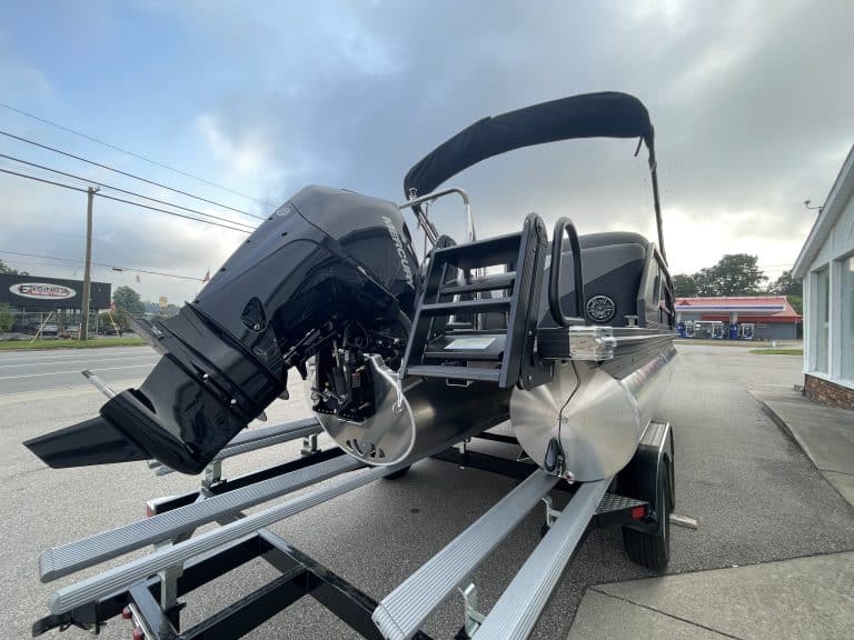 Luxury boat with powerful outboard motor and trailer at Hall's Sport Center.