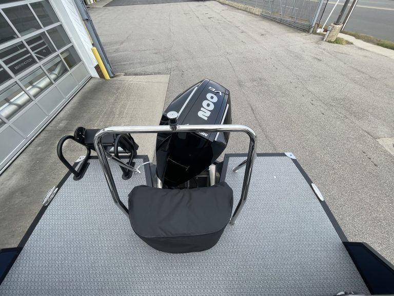 Electric boat with motor and seating on dock at Hall's Sport Center.