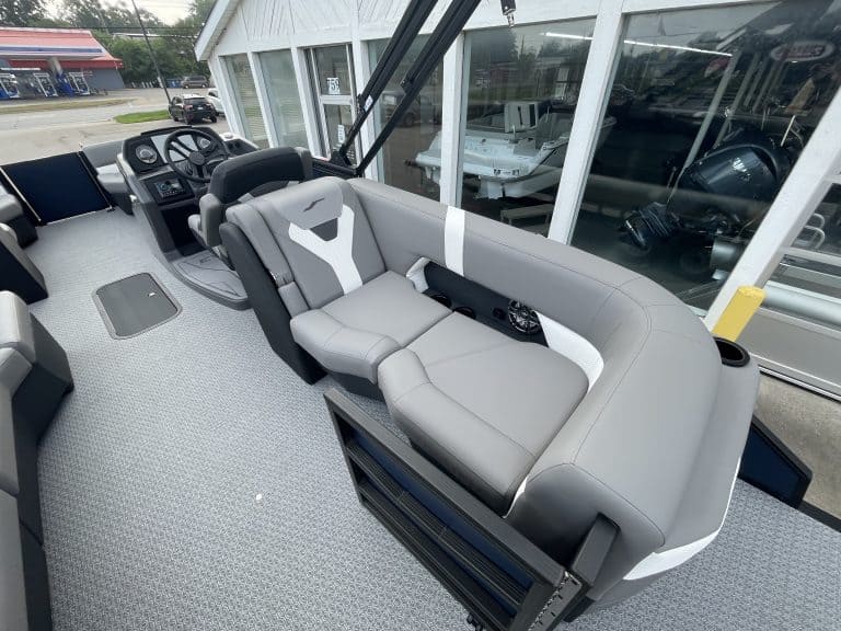 Luxury pontoon boat interior with comfortable seating and steering console.