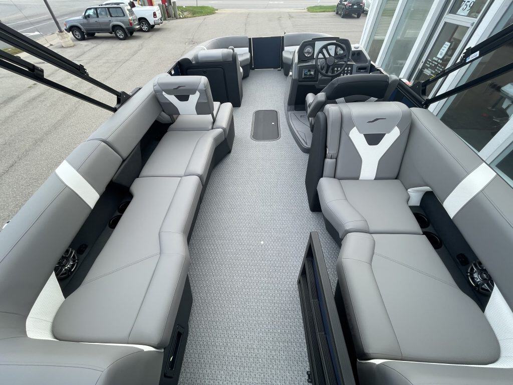Luxury pontoon boat interior with spacious seating and steering console.