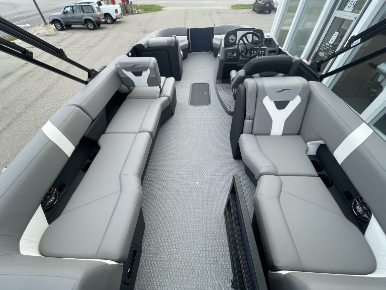Luxury pontoon boat interior with spacious seating and steering console.