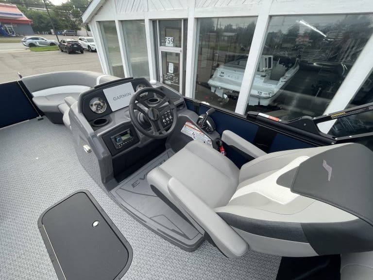 Boat cockpit with steering wheel and controls at Hall's Sport Center.