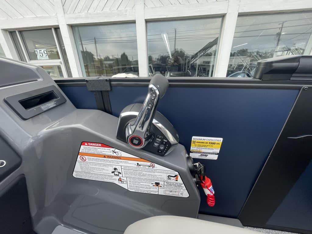 Electric scooter handlebar with safety labels at Hall's Sport Center.