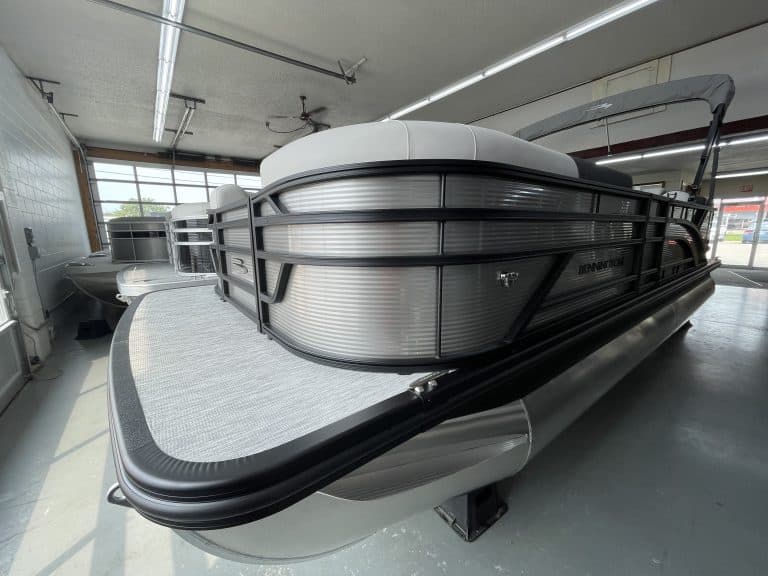 Bennington 22 S1SR pontoon boat inside Hall's Sport Center.