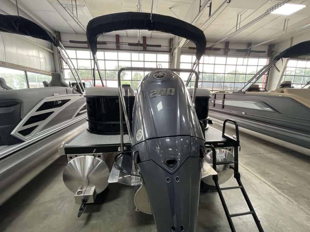 Bennington 22 S1SR pontoon boat inside Hall's Sport Center showroom.