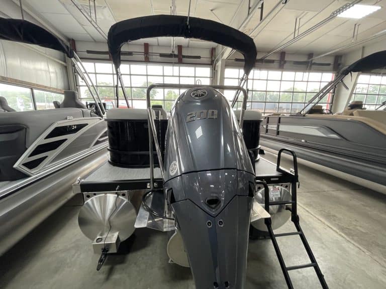 Bennington 22 S1SR pontoon boat inside Hall's Sport Center showroom.