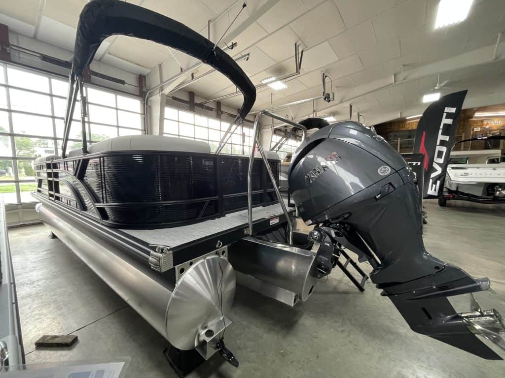 Bennington 22 S1SR pontoon boat with outboard motor inside Hall's Sport Center.