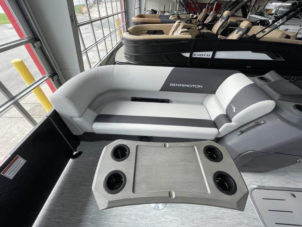 Bennington pontoon boat with comfortable seating and cup holders.