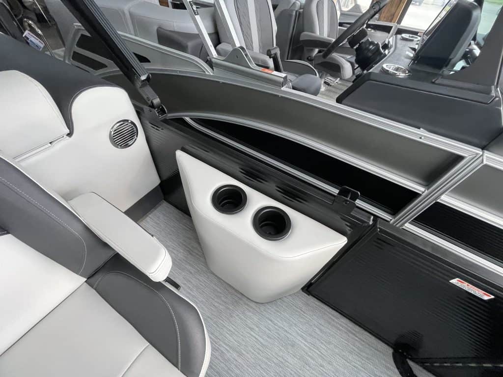 Luxury pontoon boat interior with seating and built-in speakers.