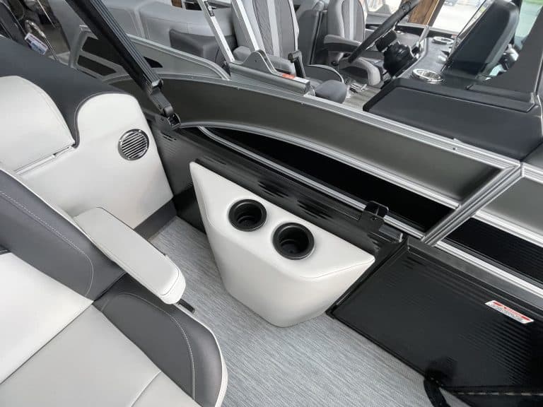 Luxury pontoon boat interior with seating and built-in speakers.