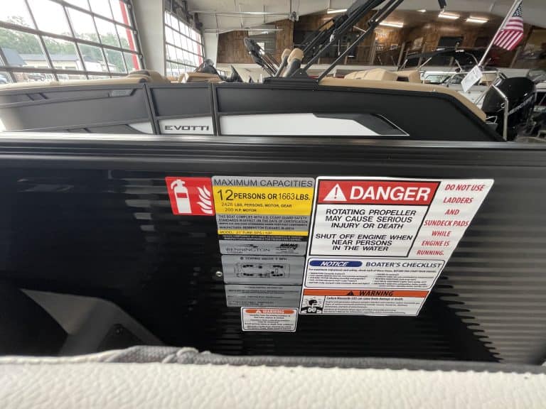 Close-up of Evotti boat with safety and capacity labels at Hall's Sport Center.