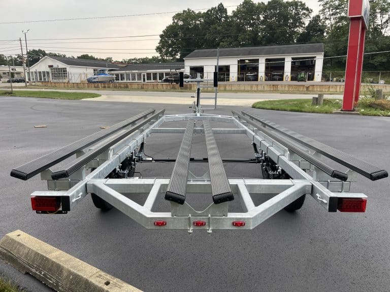 Boat trailer parked outdoors at Hall's Sport Center for sale or rent.
