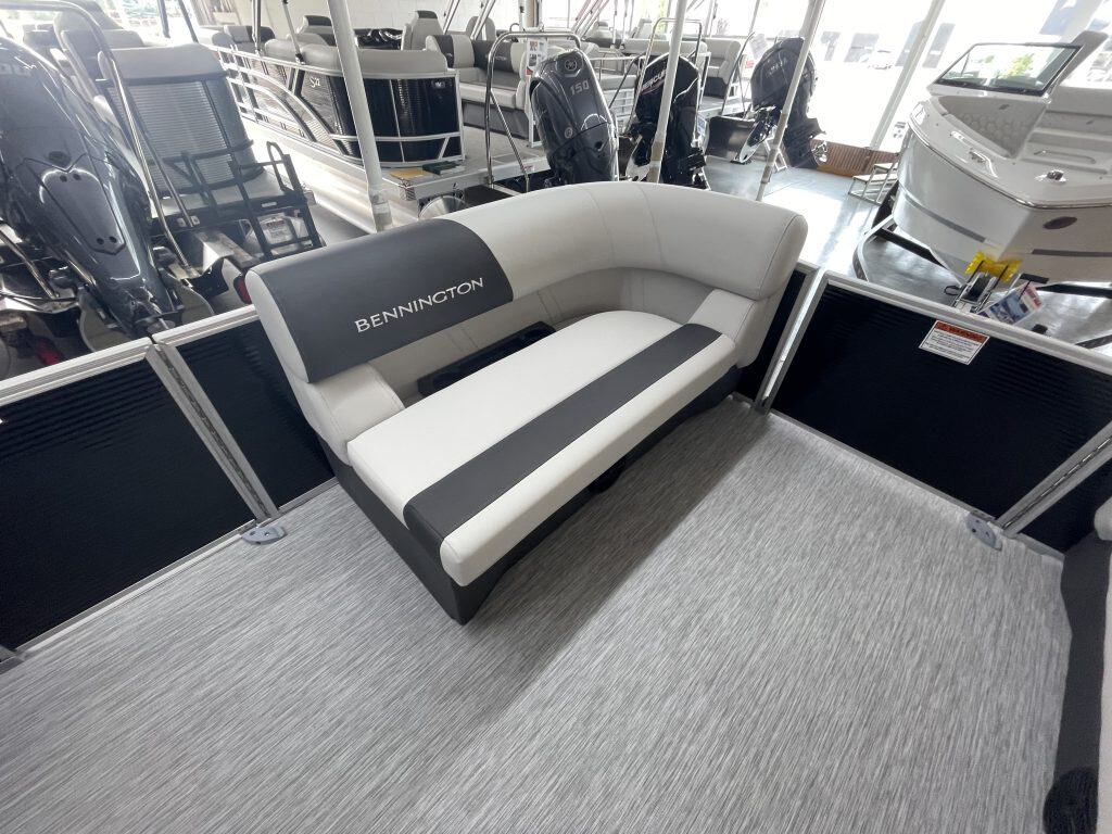 Bennington boat showroom lounge with boat models in background.