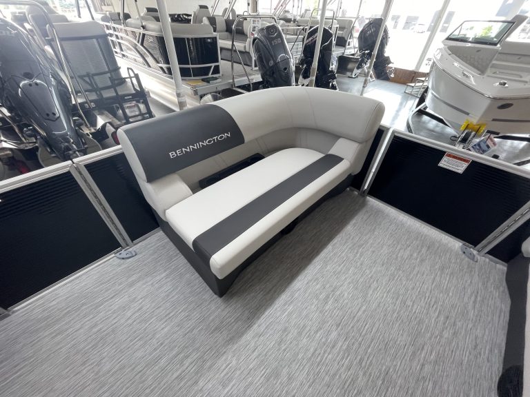 Bennington boat showroom lounge with boat models in background.